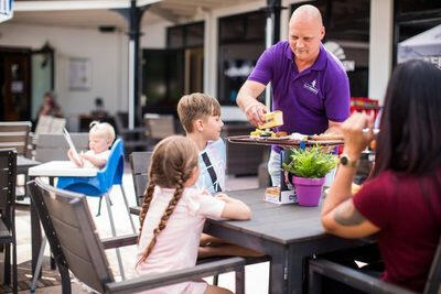 drie mensen die eten op het terras